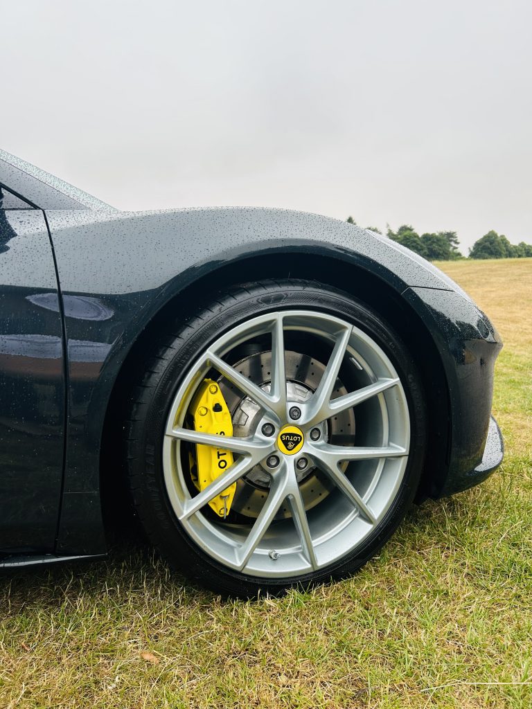 A bright yellow brake calliper on a Lotus wheel 
